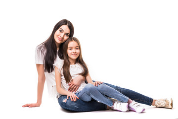 Obraz na płótnie Canvas Portrait of happy white mother and young daughter lying on the floor isolated on white background. Happy family people concept.