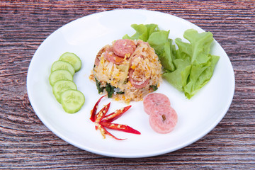 Fried  jasmine rice with Thai sour sausage topped cucumber, kale and green oat.