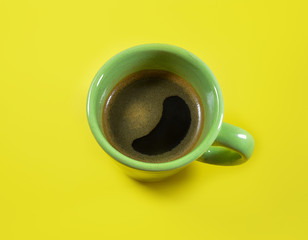 Coffee cup on yellow background