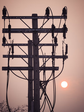 Sunrise up in the morning sky with Electrical power poles silhouette front ground.