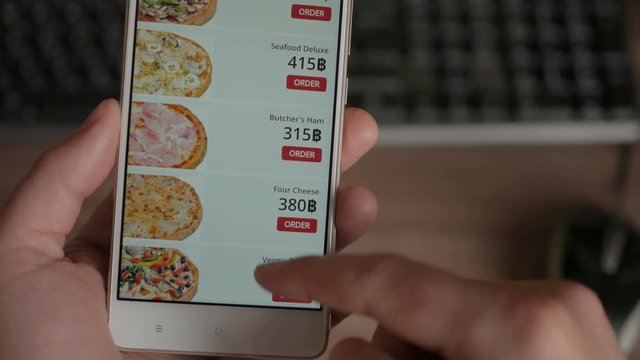 Man Orders Pizza Using Online Delivery Service With Smartphone.  Closeup. 4K UHD. LOS ANGELES - Mart 2018.