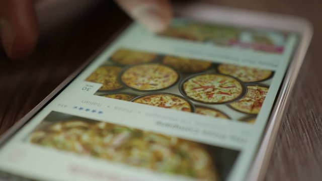 Man Orders Pizza Using Online Delivery Service With Smartphone.  Closeup. 4K UHD. LOS ANGELES - Mart 2018.