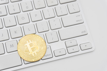 Golden Bitcoins on keyboard. Selective focus.