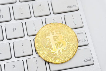 Golden Bitcoins on keyboard. Selective focus.