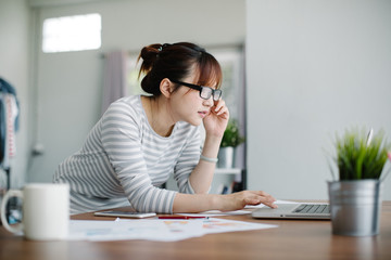 Businesswoman working online using laptop in office