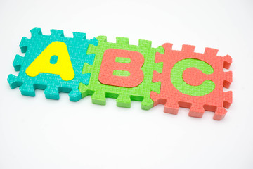 Foam puzzle with word on a white background.