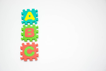 Foam puzzle with word on a white background.