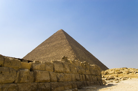 Old stone wall background with a pyramid in Giza