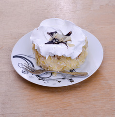 almond cake in a plate on wood background