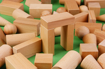 wooden geometric shapes on a green background