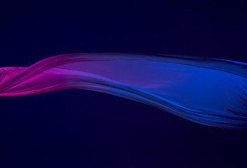 Smooth elegant transparent blue cloth separated on blue background.