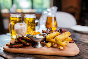Assorted beer snacks with beer mugs