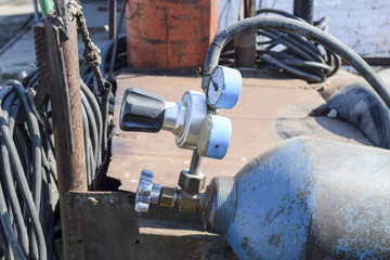 Gas welding equipment. A cylinder with propane and a cylinder with oxygen.