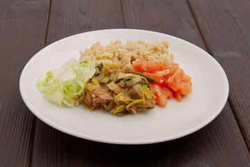 Wheat gluten on leek with couscous on a table