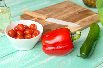 ingredients for Greek salad on green wooden table