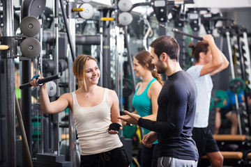 Fototapeta premium Adults doing powerlifting on machines