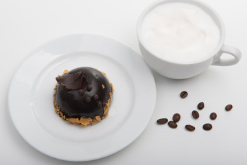 White cup of cappuccino with chocolate cake on the white background