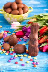 chocolate rabbit, easter eggs and tulips