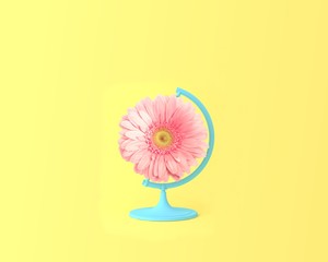 Globe sphere orb pink flower concept on pastel yellow background. minimal idea nature. An idea creative to artwork design or spring flowers and summer flowers concept.