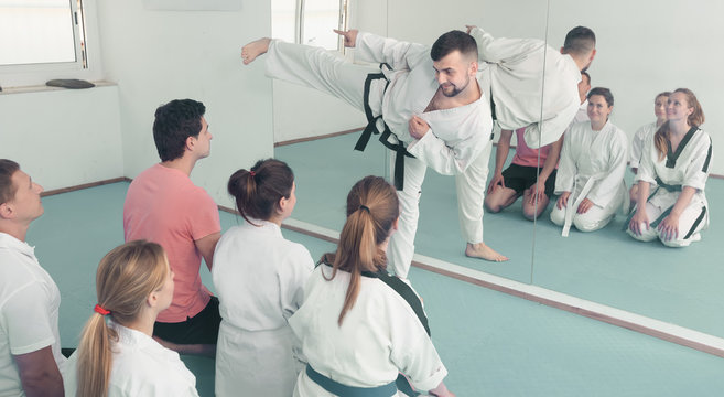 Karate coach teaching adults