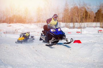 Fototapeta na wymiar Snowmobile. Snowmobile team of friends races in snow. Concept winter sports, racers.