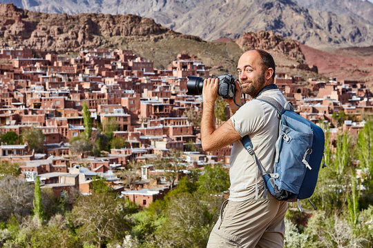 Tourism in Iran, solo traveler photographs the village of Abyaneh.