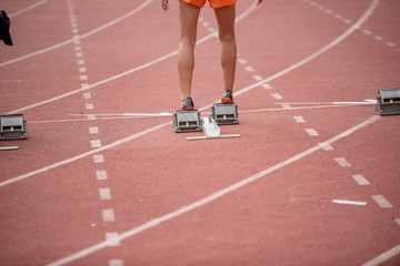 Athletics people running on red running track