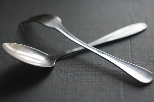 spoon and fork on a dark background