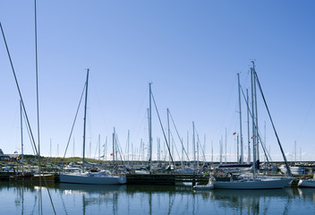 Fototapeta na wymiar Laesoe / Denmark: Sail masts dominate the scape of Oesterby Havn’s popular marina on the north-west coast of the island
