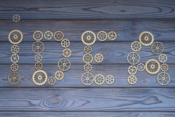 word idea made of puzzle gears on a wooden background. Business concept idea, cooperation teamwork logic strategy