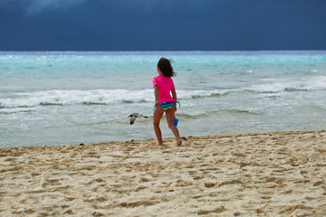 Beautiful Close-up Portrait of Six Years Old Girl, in Hot Pink Swimming Suit,  having Fun on the Mexican Beach,  Cancun Resort, Pacific Ocean, Summer Vacation, playing with ball, Big Ocean Waves