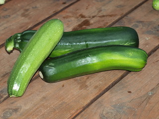 Squashes and patisons on a wooden terrace.