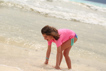 Beautiful Close-up Portrait of Six Years Old Girl, in Hot Pink Swimming Suit,  having Fun on the Mexican Beach,  Cancun Resort, Pacific Ocean, Summer Vacation, playing with ball, Big Ocean Waves