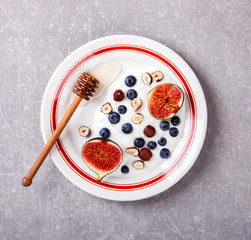 Yogurt with berries fresh figs, blueberries and honey.Food or Healthy diet concept.Super Food.Top View.selective focus.