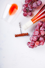 Wine Pink and Grape bunch. Alcoholic drink in a glass glass on a light background.Copy space for Text. Top View. selective focus.