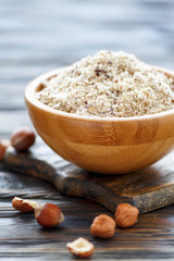 Hazelnut flour in a wooden bowl.