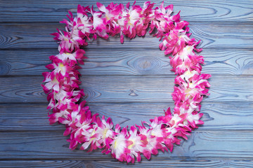 Hawaiian wreath on a wooden background. beach vacation.