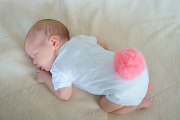 little baby is sleeping on the bed