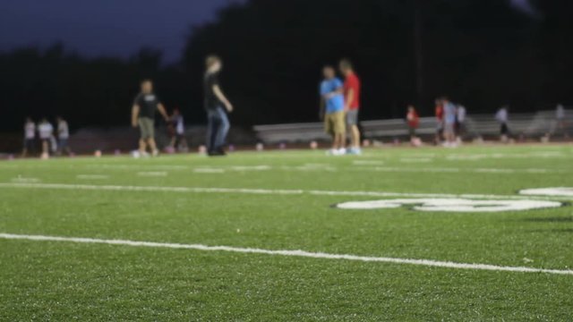 People playing on football field at event.
