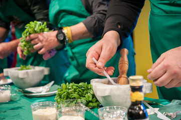 People during the preparation of the Pesto basil sauce