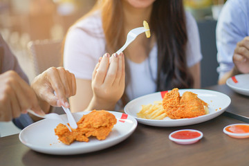 close up focus woman hand hold and showing fried chicken meal for eat at restaurant bar,fast food concept,healthcare living