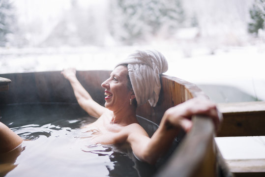 Cheerful topless woman in plunge tub