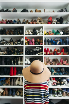 Person in front of shelves with different shoes