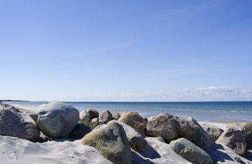 Laesoe / Denmark: Boulders at a beach access in Vesteroe Havn on a sunny day in April
