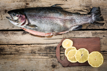 Fresh trout fish with spices on wood