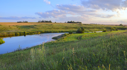 Fototapeta na wymiar Summer landscape with river.Green hills, fields and meadows.River Upa in Tula region, Russia.Colorful sunset.Quiet stream.Calm.Twilight.Beautiful clouds in blue sky.