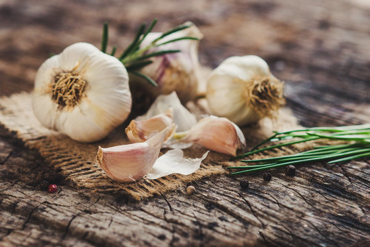 Fresh garlic on rustic background