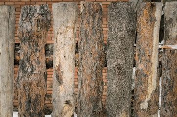 Wooden timber fence made of pine logs background. Construction site. Fence on the backyard of countryside house.