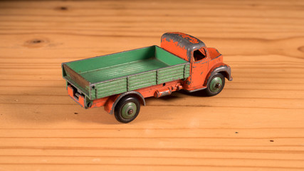 Old retro metal toy truck on wooden table 