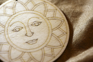 Fototapeta na wymiar Carved wooden sun decoration